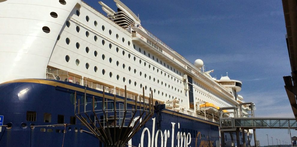 a large cruise ship docked at a dock